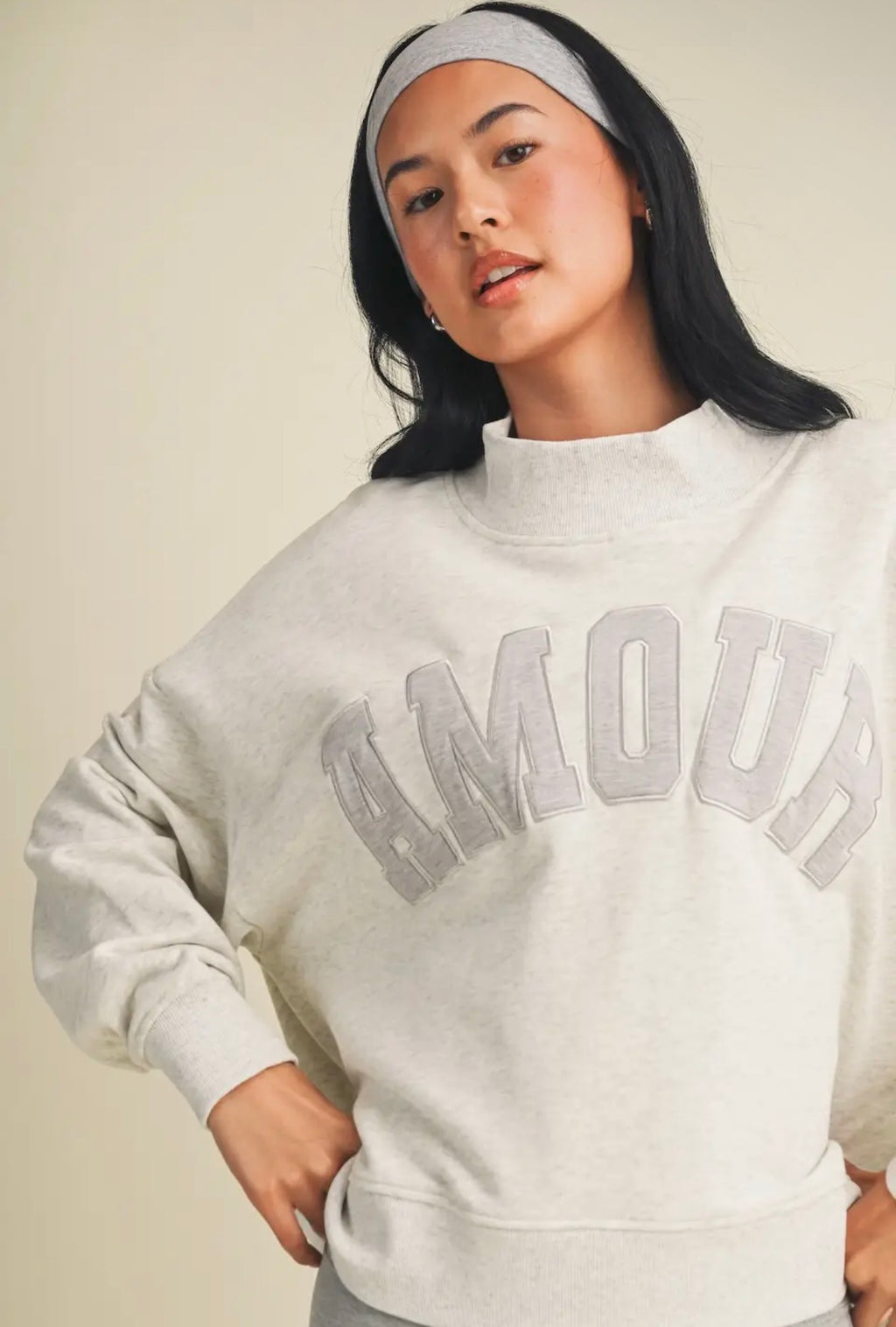 Close-up detail of Amour graphic on heather grey oversized mock neck sweatshirt