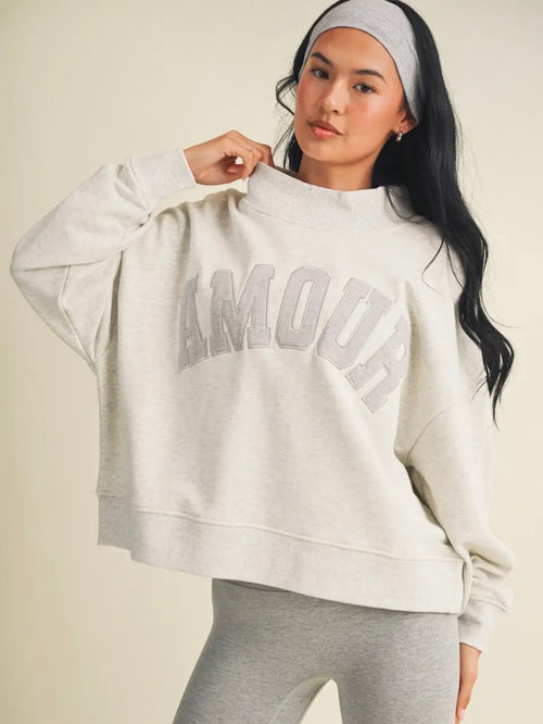 Model wearing heather grey Amour oversized mock neck sweatshirt