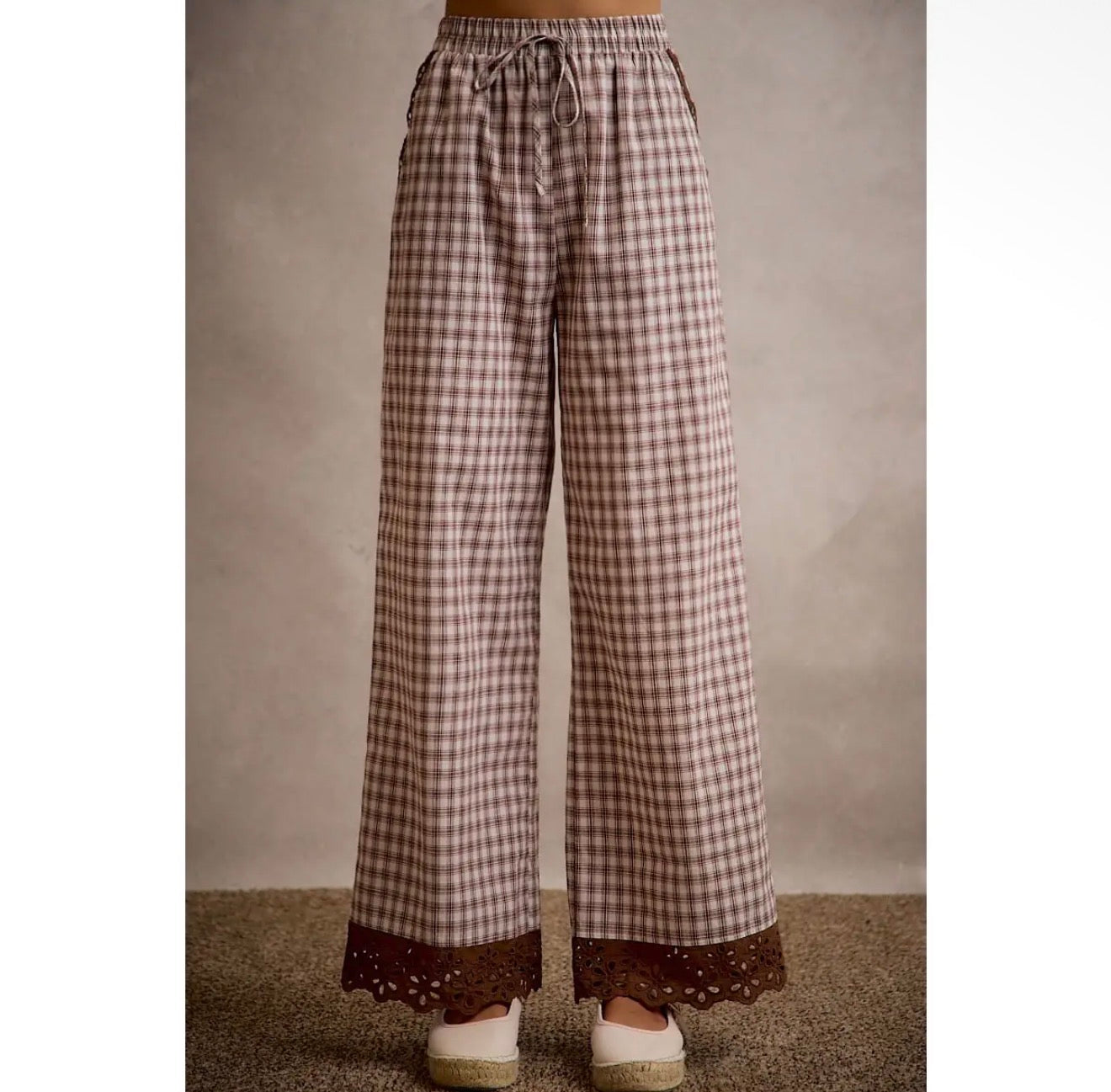 Full-length front view of brown plaid wide leg pants with lace hem