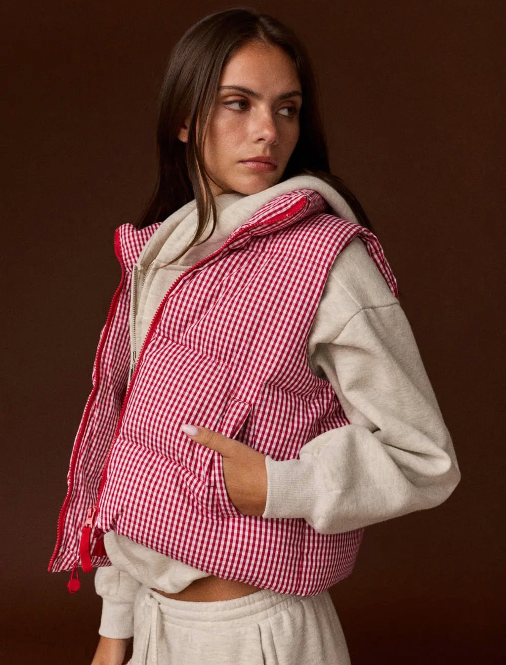 Model wearing red and white gingham puffer vest