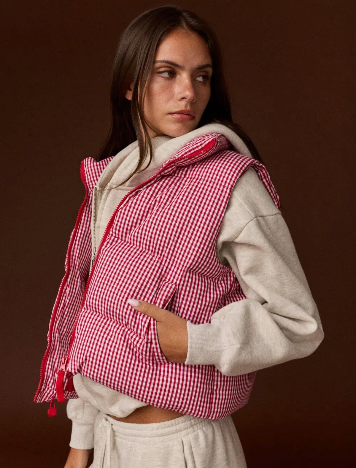 Model wearing red and white gingham puffer vest
